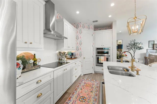 a living room with fireplace furniture and a chandelier