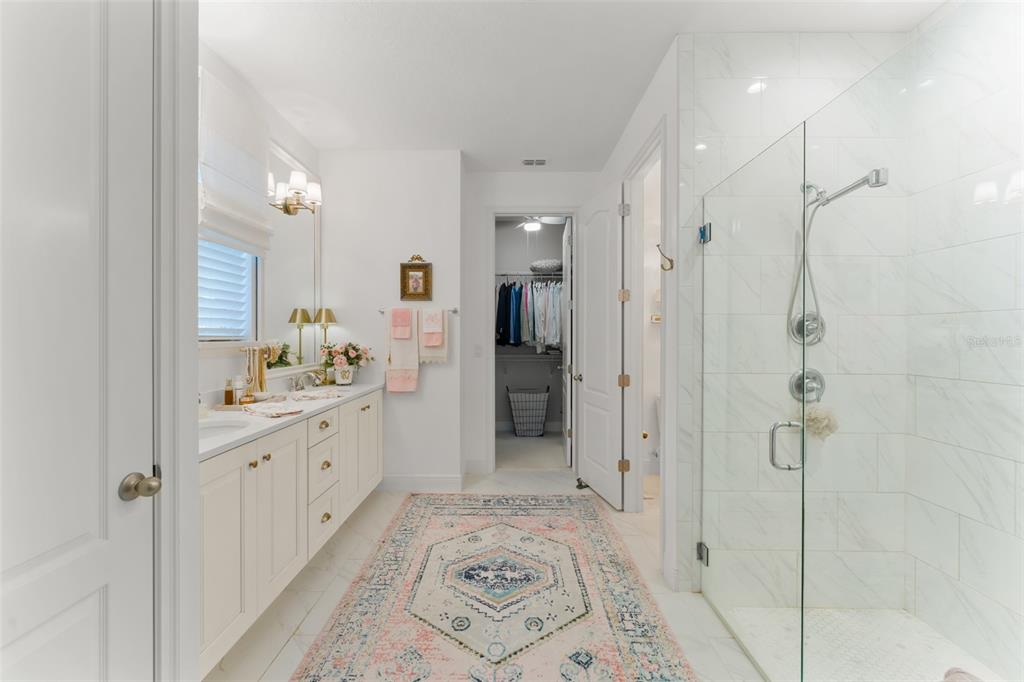 2983 Rapollo Lane Apopka, FL 32712 - Photo 40 of 62 a spacious bathroom with a granite countertop sink mirror and shower