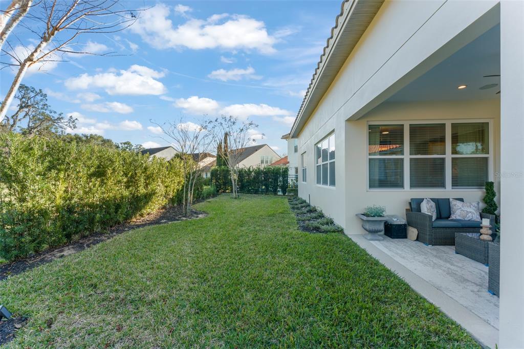 2983 Rapollo Lane Apopka, FL 32712 - Photo 47 of 62 a view of a house with backyard sitting area and garden