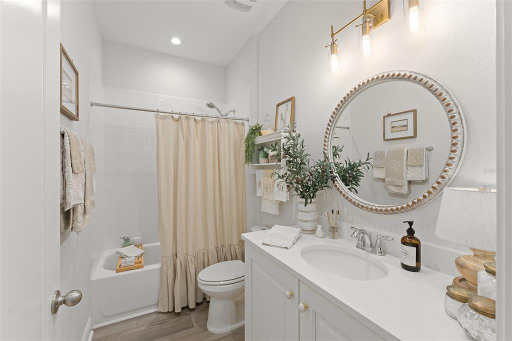 2983 Rapollo Lane Apopka, FL 32712 - Photo 6 of 62 a bathroom with a sink a toilet and a mirror