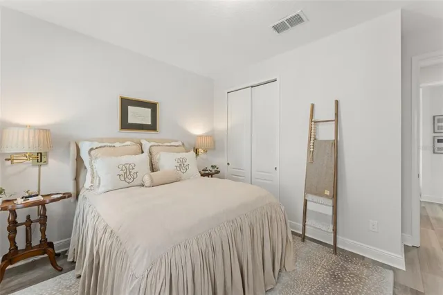 a bedroom with a bed flat screen tv and a potted plant