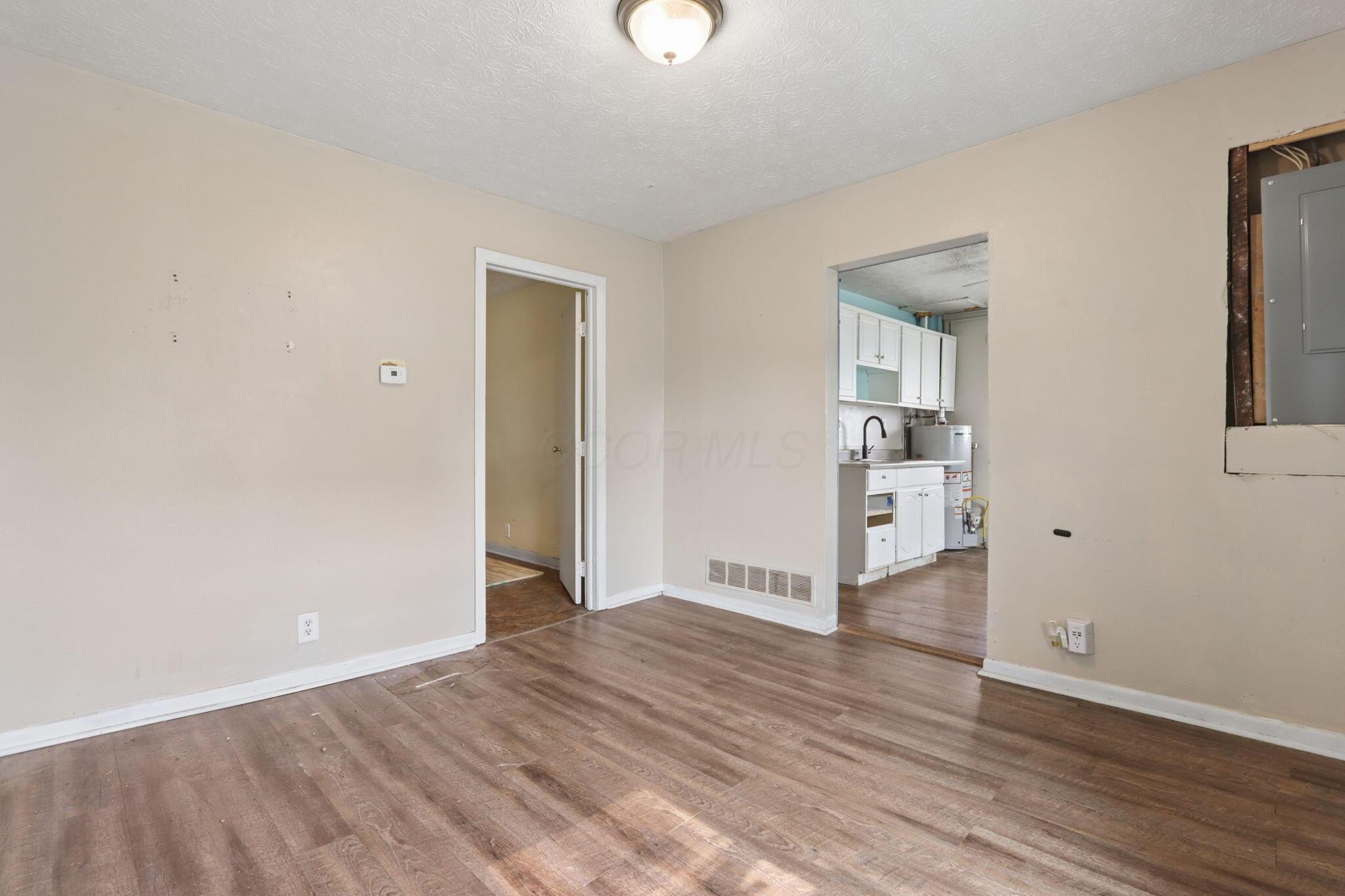 1128 Hilock Road Columbus, OH 43207 - Photo 7 of 29 Living room with wood-look flooring and abundant natural light.