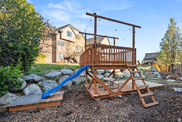 1205 North Elk Rdg Lane, Unit 202 Alpine, UT 84004 - Photo 73 of 88 Multi-level wooden play structure featuring a slide and sandpit