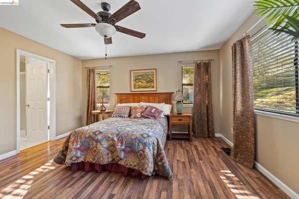 a bed room with a bed and a potted plant