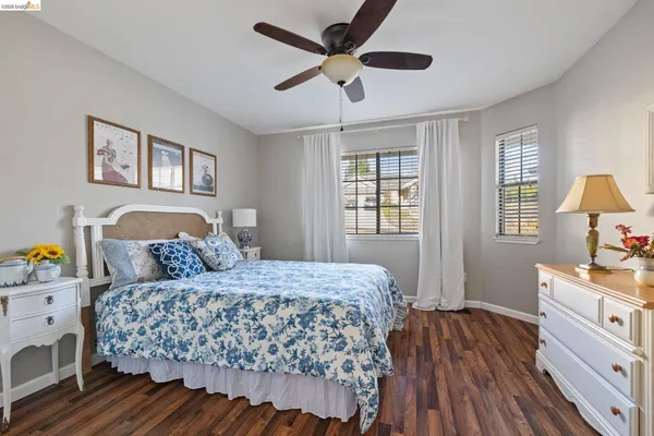 a view of a hallway view with living room and wooden floor