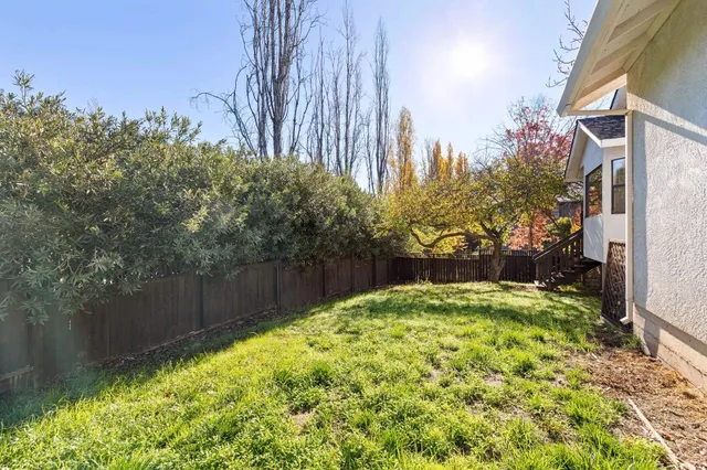 a view of a chairs and tables in the back yard of the house