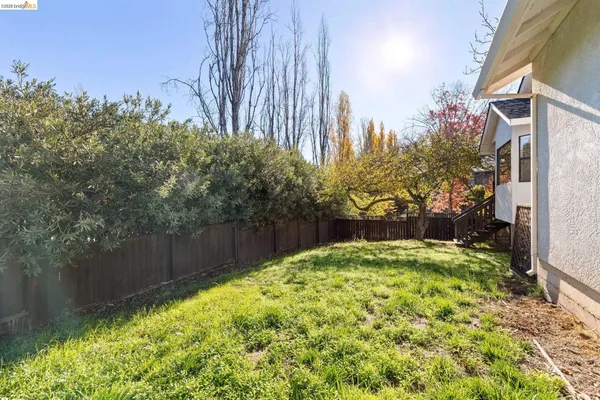 a view of a chairs and tables in the back yard of the house
