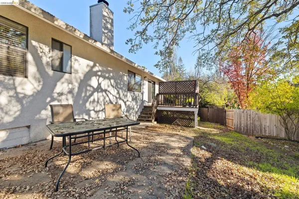 a view of a patio with a table and chairs