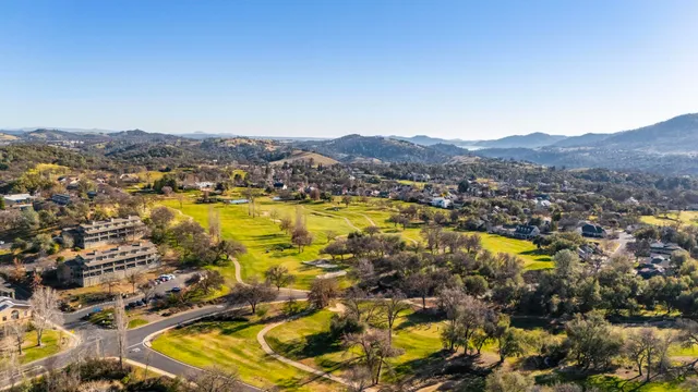 an aerial view of residential house with outdoor space and mountain view