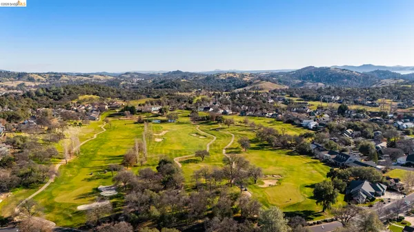 an aerial view of a house with a yard