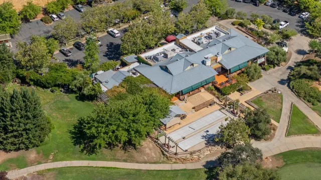 an aerial view of a house with a garden and mountains