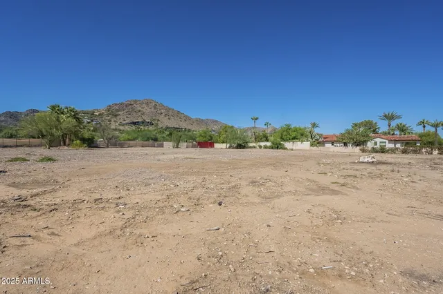 a view of dirt road with a building in the background