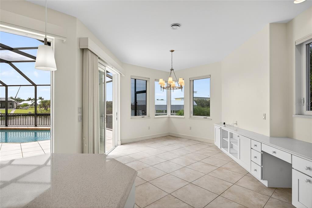 15435 Appleton Boulevard Port Charlotte, FL 33981 - Photo 13 of 49 a large white room with a large window and chandelier