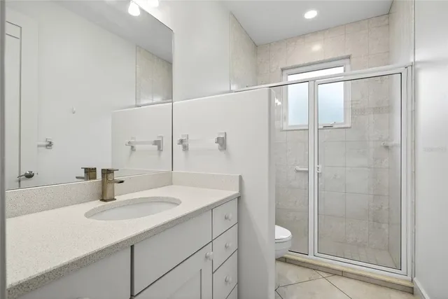 a bathroom with a sink shower and a mirror