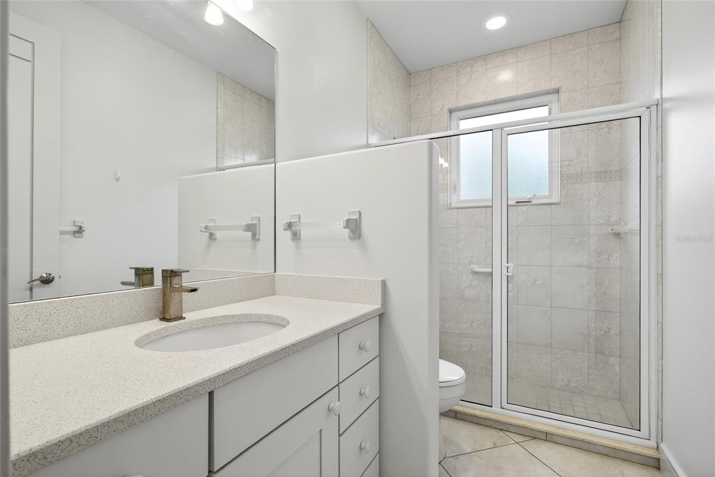 15435 Appleton Boulevard Port Charlotte, FL 33981 - Photo 20 of 51 a bathroom with a sink shower and a mirror
