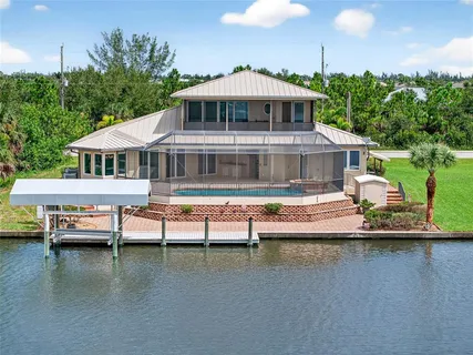 a view of a house with swimming pool and a yard
