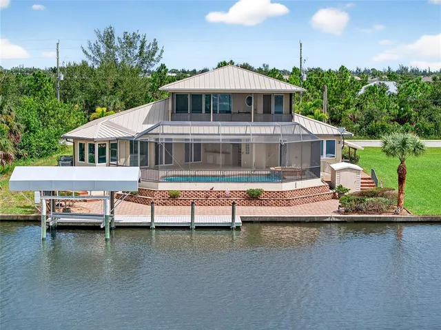 a view of a house with swimming pool and a yard