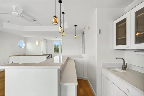 a bathroom with a granite countertop sink and a shower