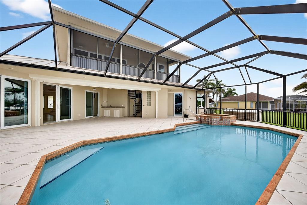 15435 Appleton Boulevard Port Charlotte, FL 33981 - Photo 36 of 51 a view of a house with pool and dining table and chairs