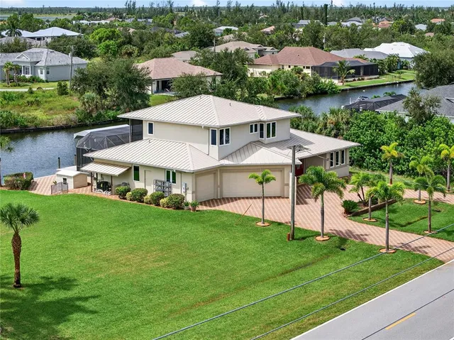 an aerial view of a house with a yard