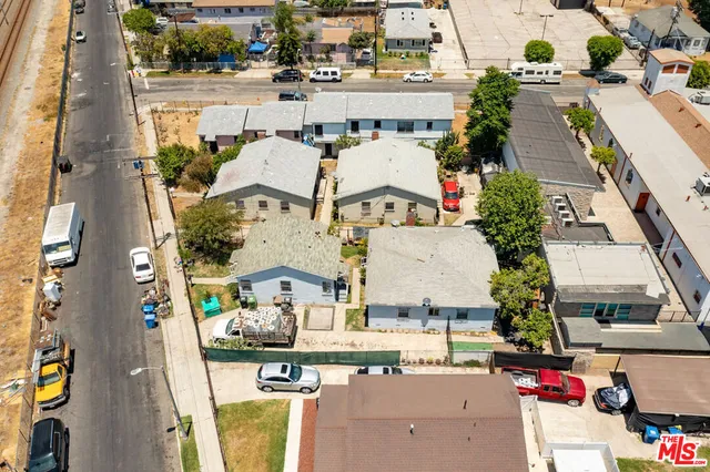 an aerial view of residential houses with outdoor space