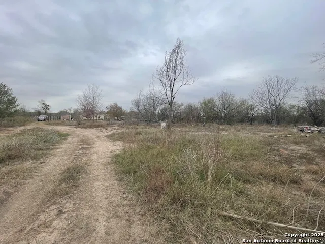 a view of a field with wooden fence