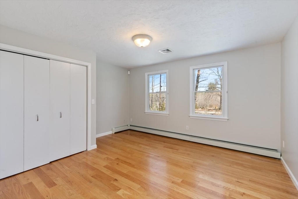 270 Salem Road Dracut, MA 01826 - Photo 18 of 42 a view of an empty room with wooden floor and a window