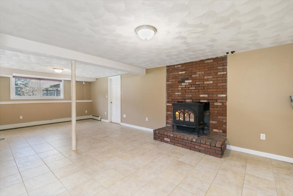 270 Salem Road Dracut, MA 01826 - Photo 24 of 42 a view of a livingroom with fireplace and window