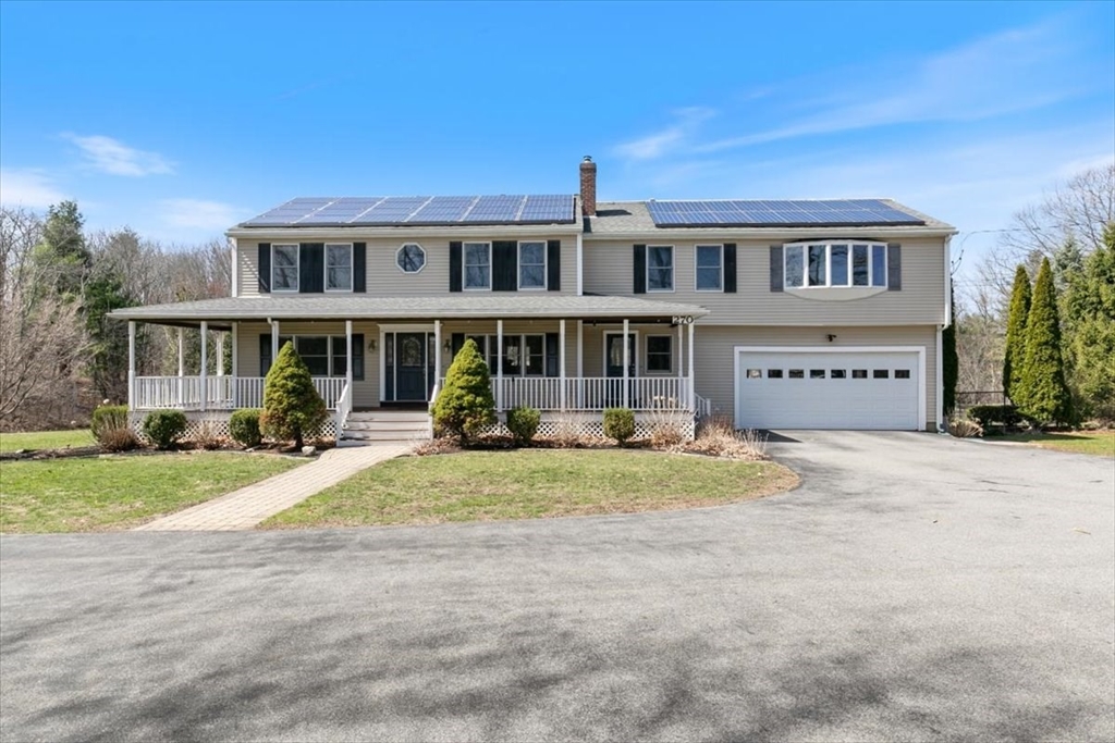 270 Salem Road Dracut, MA 01826 - Photo 30 of 42 a front view of a house with a garden and balcony
