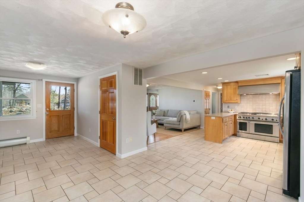 270 Salem Road Dracut, MA 01826 - Photo 5 of 42 a kitchen with stainless steel appliances a refrigerator and a stove top oven