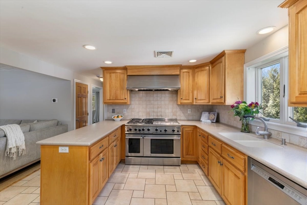 270 Salem Road Dracut, MA 01826 - Photo 6 of 42 a kitchen with stainless steel appliances a stove sink and cabinets