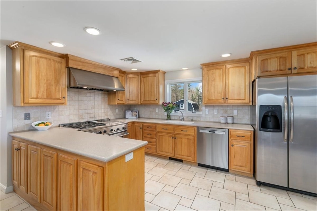 270 Salem Road Dracut, MA 01826 - Photo 7 of 42 a kitchen with stainless steel appliances granite countertop a stove a sink dishwasher and a refrigerator