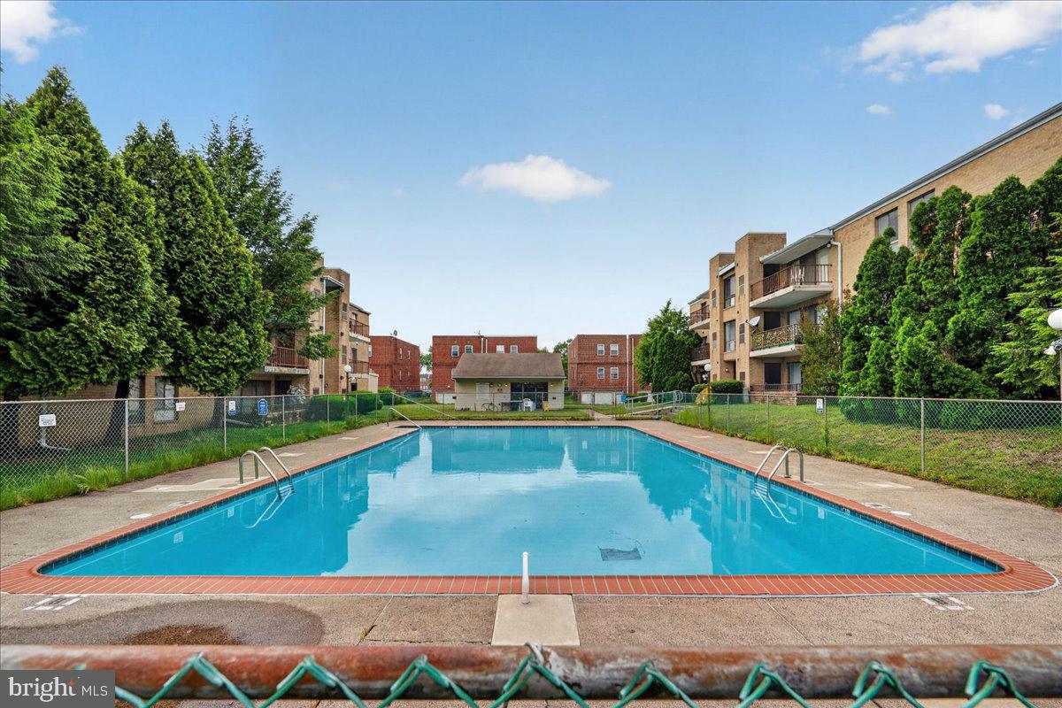 8930 Krewstown Road, Unit 310 Philadelphia, PA 19115 - Photo 27 of 32 a view of a swimming pool with a yard