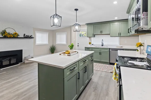 an empty room with a fireplace and wooden floor