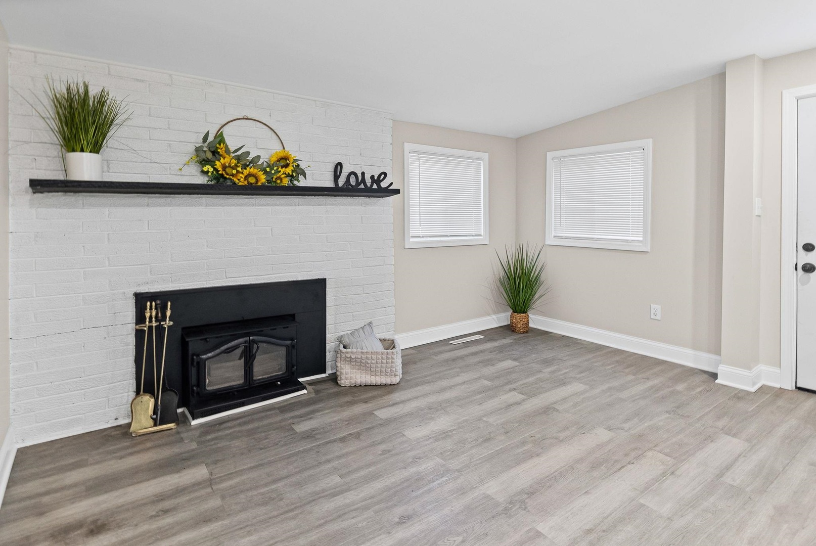 101 Marilyn Avenue Centralia, IL 62801 - Photo 21 of 34 an empty room with a fireplace and wooden floor