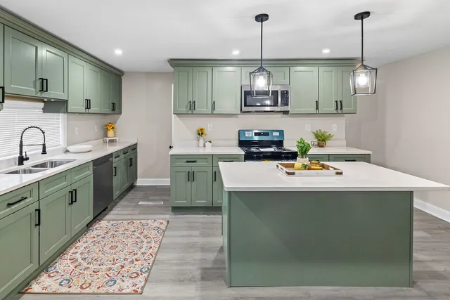 a kitchen with a sink cabinets and wooden floor
