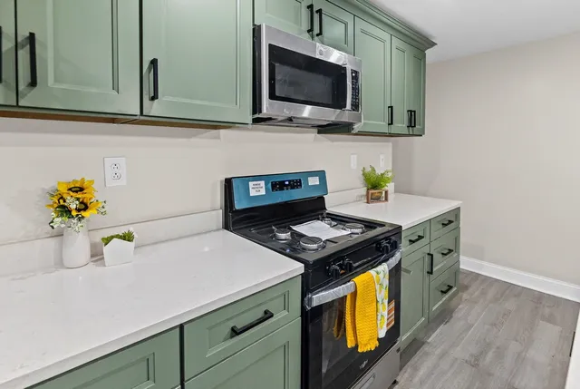 a view of kitchen island with wooden floor and fireplace