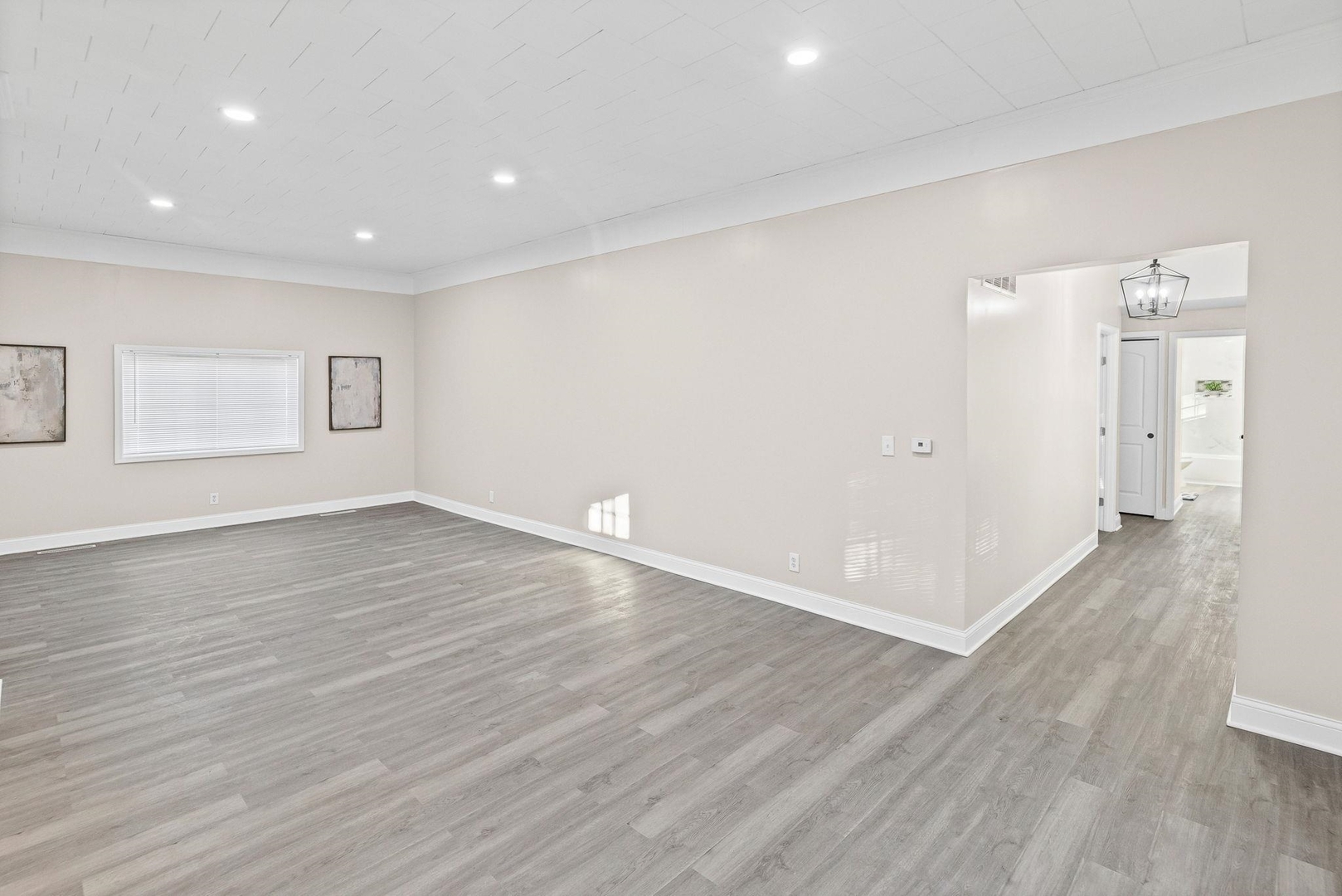 101 Marilyn Avenue Centralia, IL 62801 - Photo 7 of 34 an empty room with wooden floor and windows