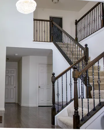 a view of entryway with wooden floor and stairs
