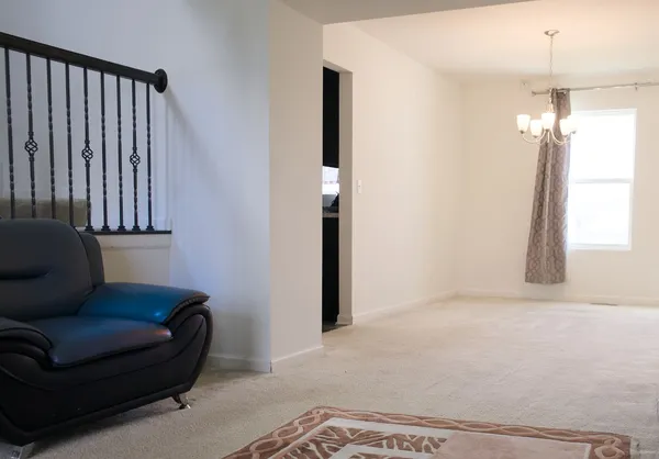 a living room with furniture and a chandelier