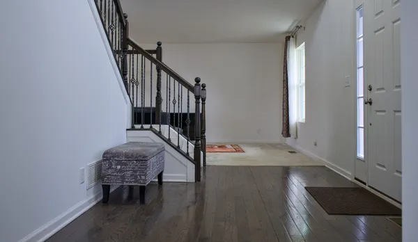 a view of an entryway with wooden floor