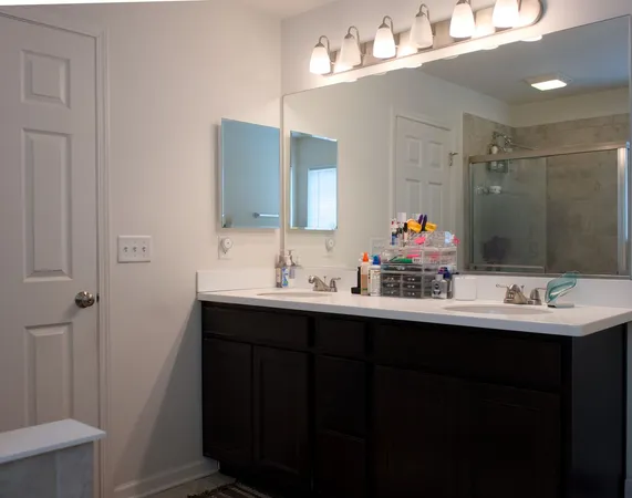 a bathroom with double sink and mirror