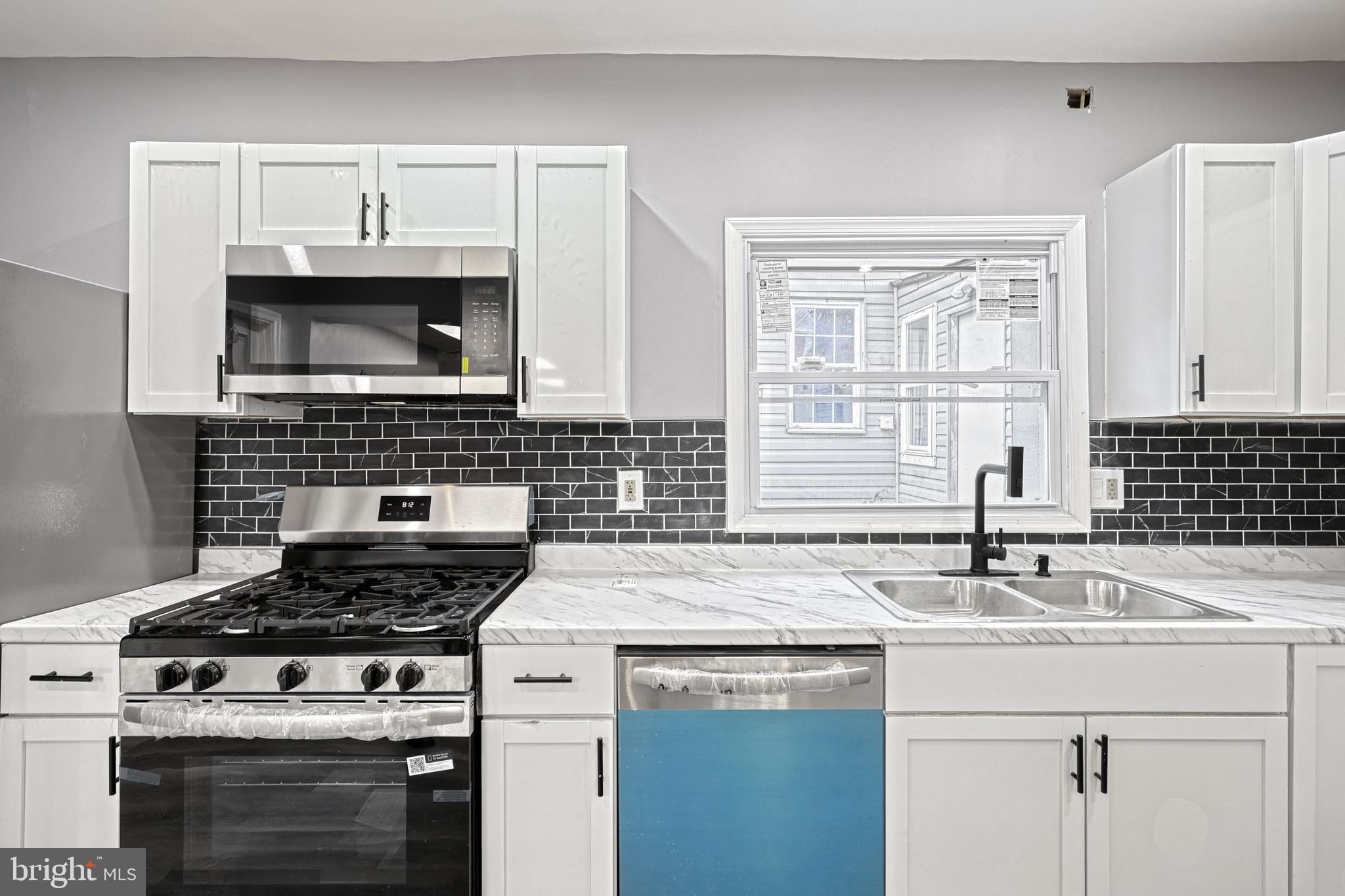 301 State Street Steelton, PA 17113 - Photo 23 of 44 a kitchen with granite countertop a sink stove and cabinets