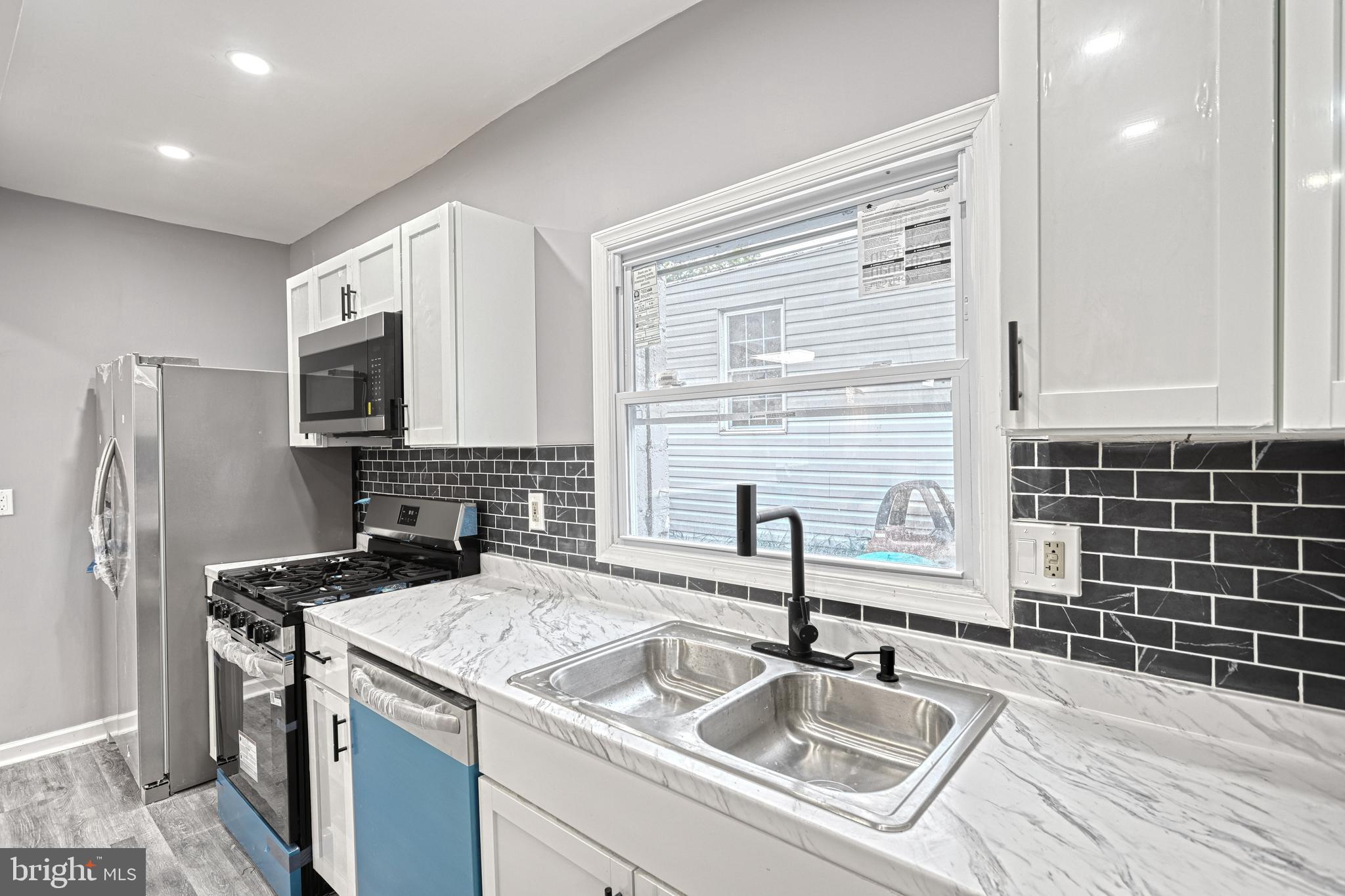 301 State Street Steelton, PA 17113 - Photo 24 of 44 a kitchen that has a sink and a stove