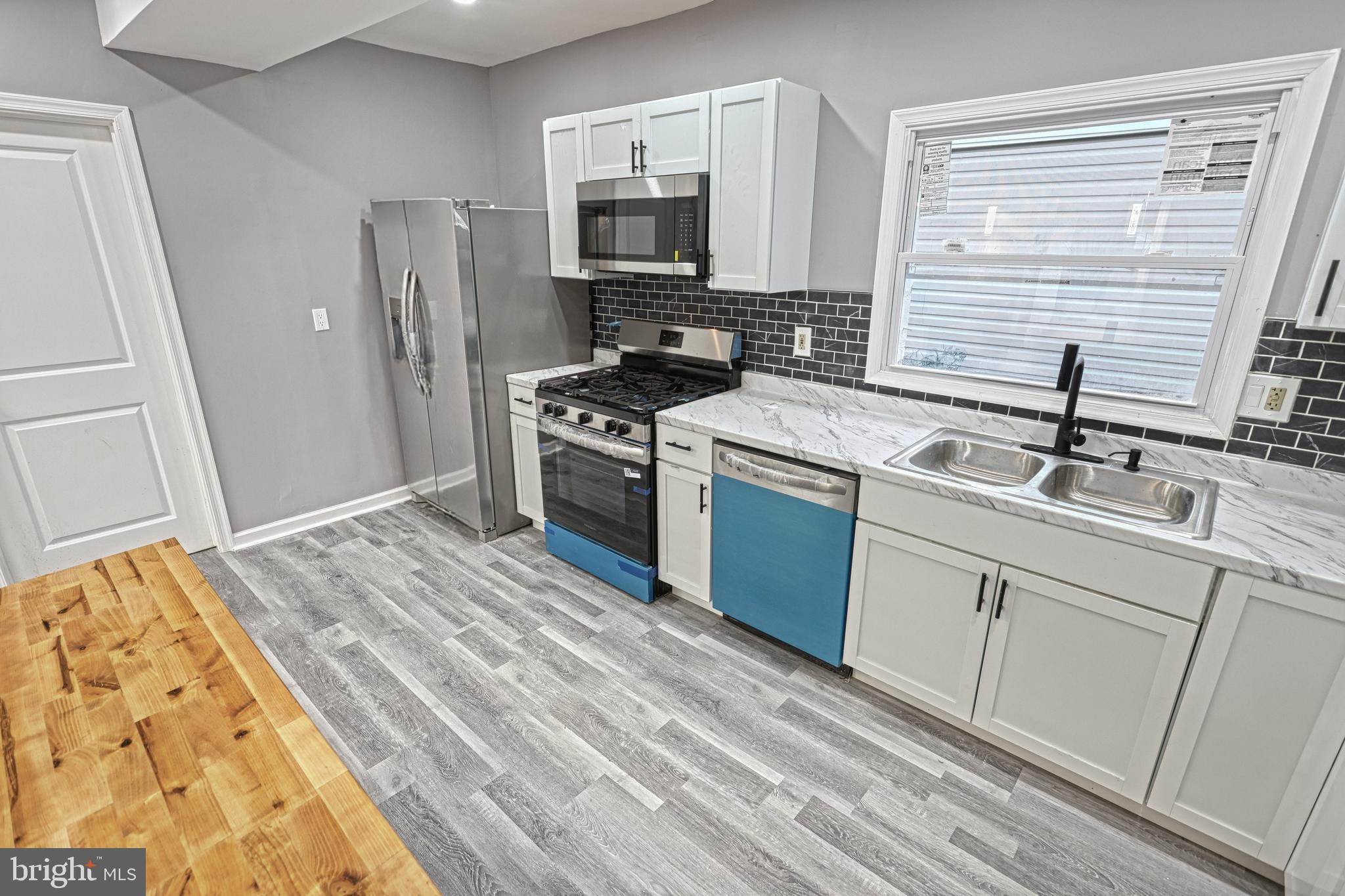 301 State Street Steelton, PA 17113 - Photo 27 of 44 a kitchen with a sink stove and refrigerator