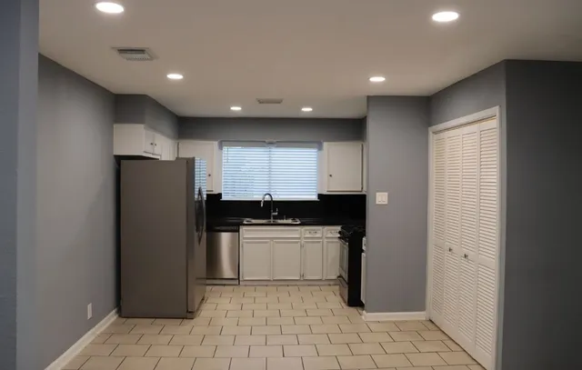 a kitchen with stainless steel appliances a refrigerator and a sink