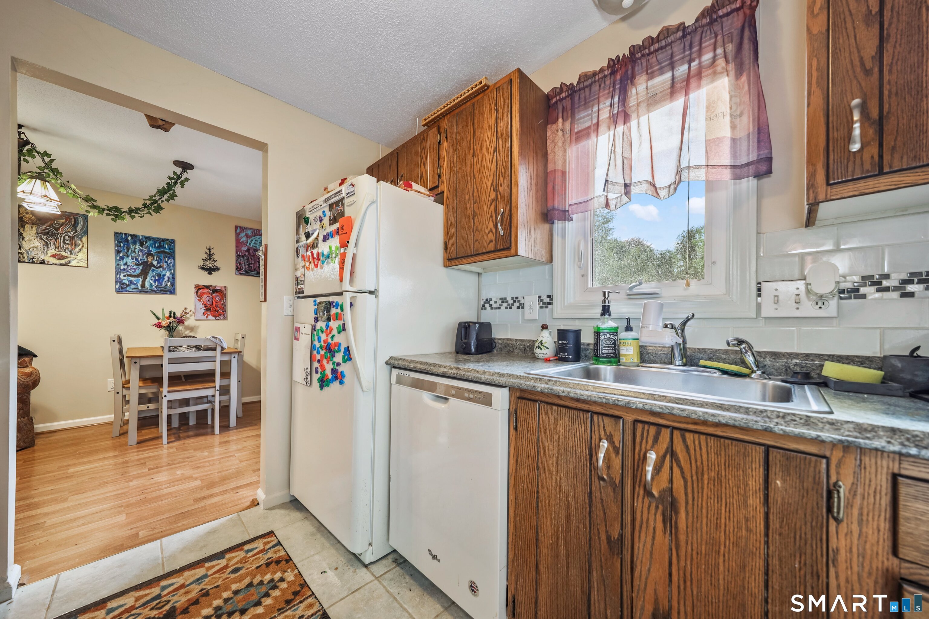 349 Allen Road, Unit 34C Torrington, CT 06790 - Photo 13 of 31 a kitchen with granite countertop a sink cabinets and window
