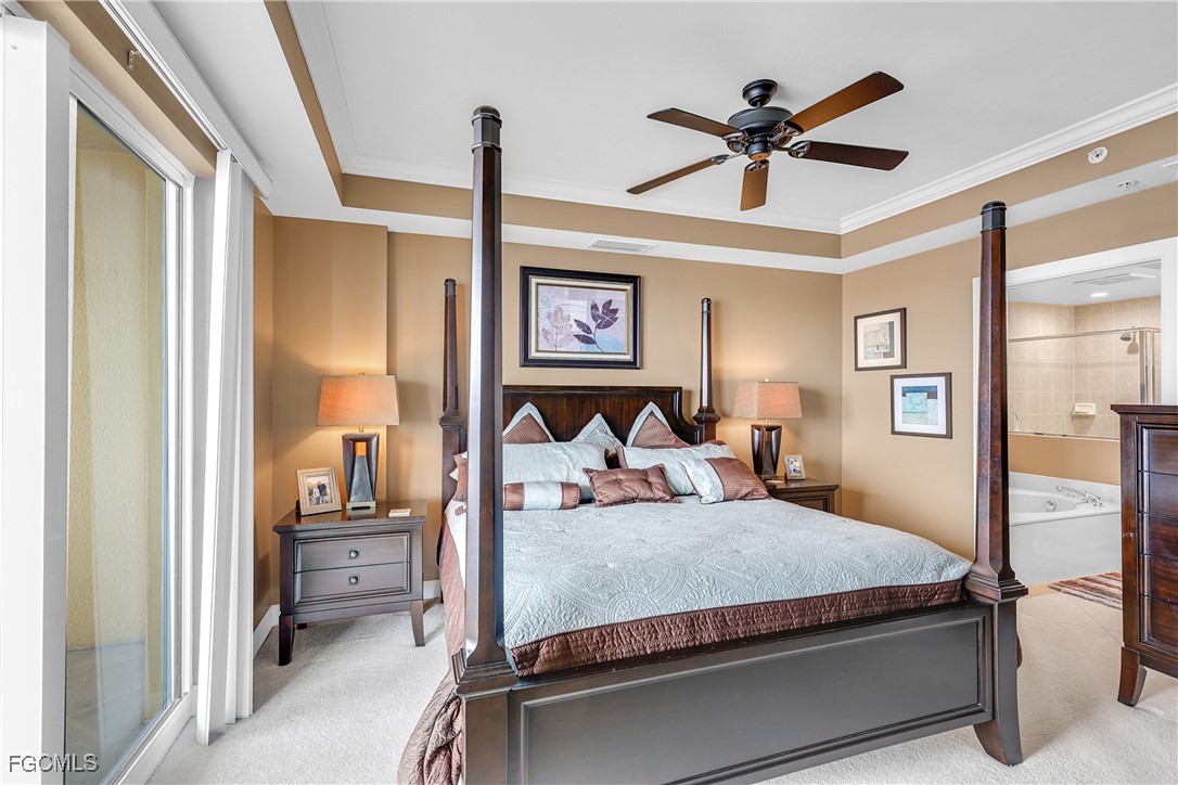 2743 First Street, Unit 1502 Fort Myers, FL 33916 - Photo 16 of 35 a bed room with a bed and a ceiling fan