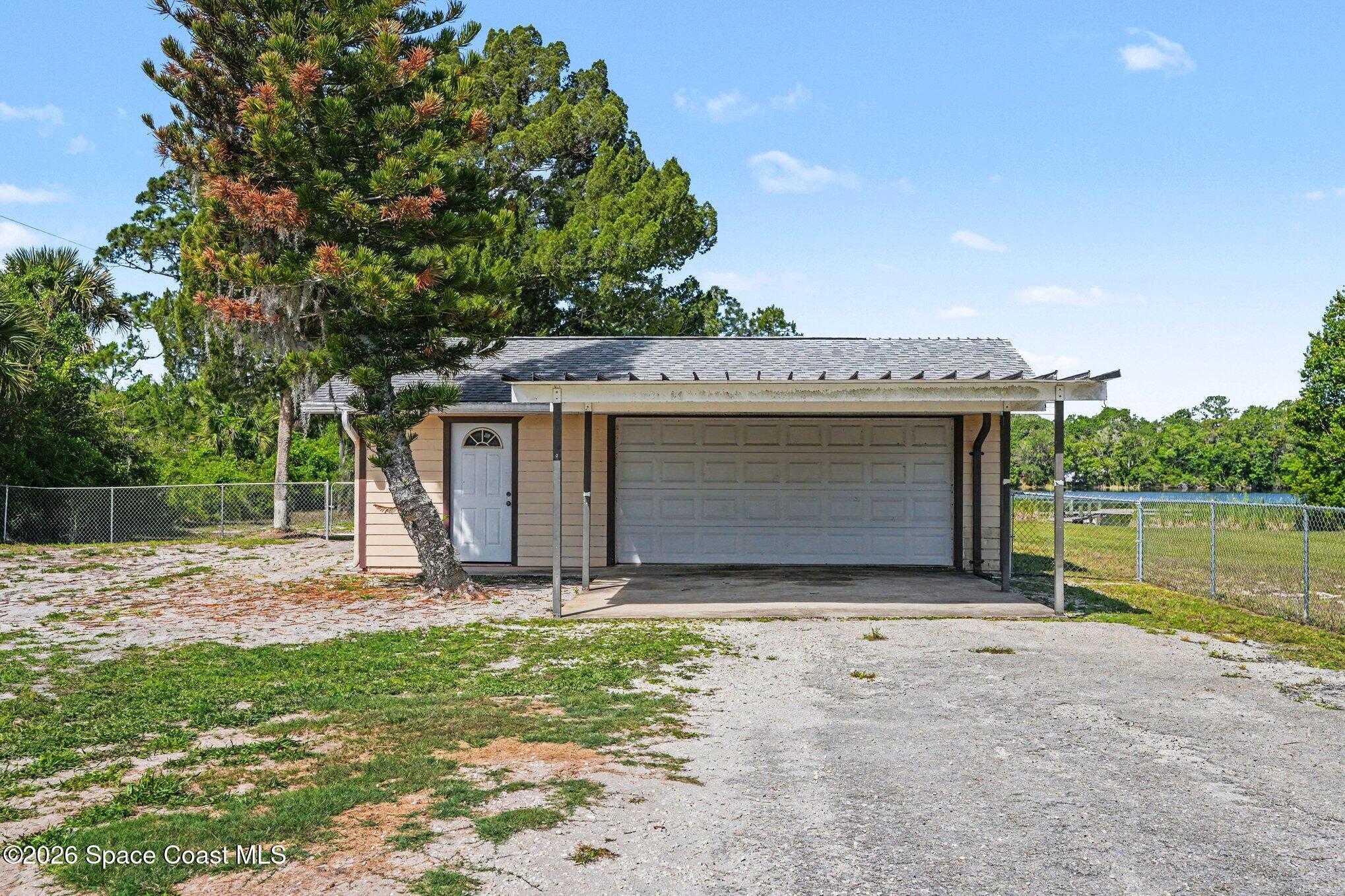 4950 Blounts Ridge Road Mims, FL 32754 - Photo 27 of 40 a view of a house with a yard and garage