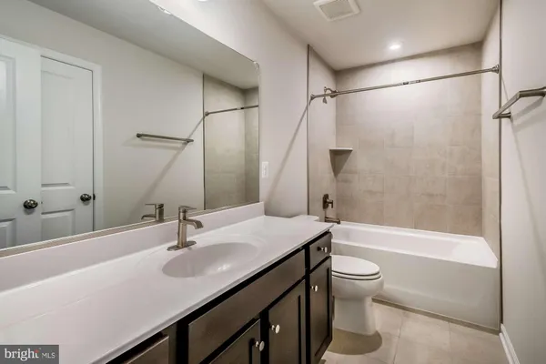 a bathroom with a sink a toilet and a bathtub